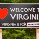 a road sign that states welcome to Virginia, Virginia is for sports betting