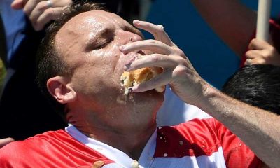 Joey Chestnut shoving a hot dog into his mouth
