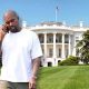 Kanye West in front of the White House talking on a cell phone