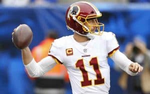 Alex Smith getting ready to throw a football