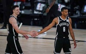 two Brooklyn Nets players giving each other a five