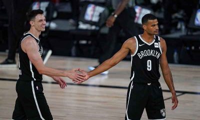 two Brooklyn Nets players giving each other a five