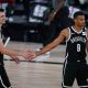 two Brooklyn Nets players giving each other a five