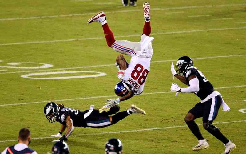 Giants player getting flipped by an Eagles player