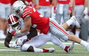 Ohio State player tackling an Indiana player