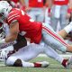 Ohio State player tackling an Indiana player