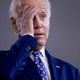Biden holding his hand to his forehead