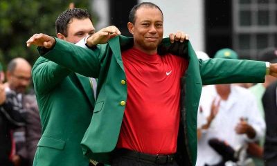 Tiger Woods putting on green jacket at Masters 2019