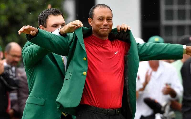 Tiger Woods putting on green jacket at Masters 2019