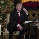 Trump on the phone in front of a Christmas Tree