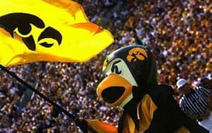 iowa mascot herky the hawk waving a university of iowa flag