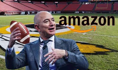 Amaon's Jeff Bezos throws a football while he considers his NFL betting odds to purchase the Washington Football Team