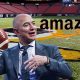 Amaon's Jeff Bezos throws a football while he considers his NFL betting odds to purchase the Washington Football Team