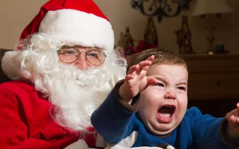 sad santa with screaming child