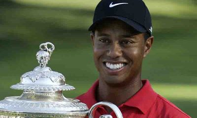 image of Tiger Woods holding trophy