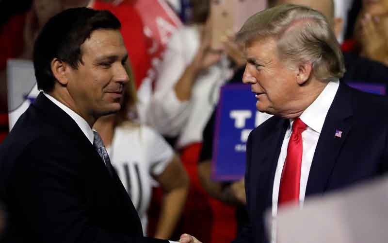 Ron DeSantis and Donald Trump shaking hands