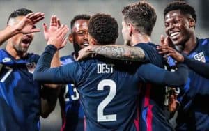 Team USA celebrating a goal against Iran in the 2022 World Cup
