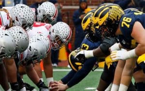 The Ohio State Buckeyes and Michigan Wolverines football teams lined up against each other