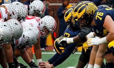 The Ohio State Buckeyes and Michigan Wolverines football teams lined up against each other