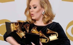 Adele holding a bunch of Grammy Awards