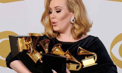 Adele holding a bunch of Grammy Awards
