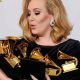 Adele holding a bunch of Grammy Awards