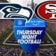 logos for the San Francisco 49ers Seattle Seahawks and Thursday Night Football in front of Lumen Field