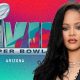 Rihanna in front of a logo for Super Bowl LVII Arizona