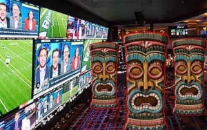 three tiki statues in a Hawaiian sportsbook venue
