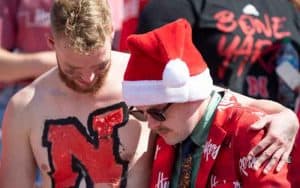 Two Nebraska Cornhuskers fans console each other