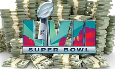 A Super Bowl LVII logo over a stacks of cash