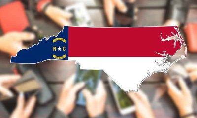 the state of North Carolina over several sets of hands holding smartphones