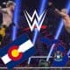 WWE logo above Colorado state flag and map of Michigan in front of a wrestling match