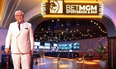 Col Sanders standing in the entryway to a Kentucky sportsbook