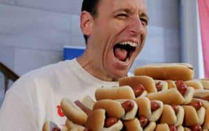 Joey Chestnut preparing to eat a stack of hot dogs