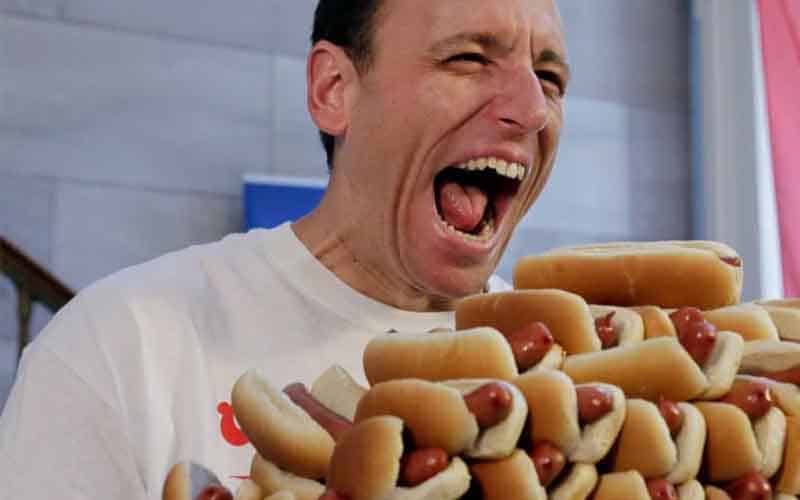 Joey Chestnut preparing to eat a stack of hot dogs