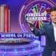 Ryan Seacrest hosting an episode of Wheel of Fortune