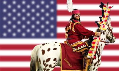 Chief Osceola of the FSU Seminoles on horseback in front of a USA flag