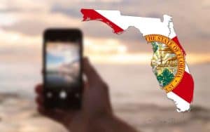 mobile sports betting on a FL beach with a state map of Florida overlaid