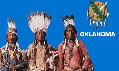 Oklahoma Native American Tribe members in front of an OK state flag