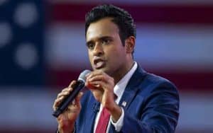 2024 GOP candidate Vivek Ramaswamy speaking in front of an American flag