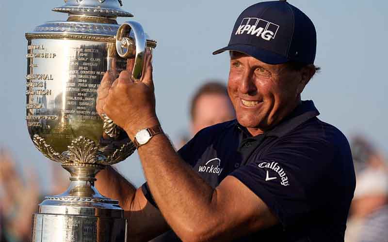 pro golfer Phil Michelson hoisting a trophy
