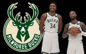 Giannis Antetokounmpo and Damian Lillard standing in front of a Bucks logo