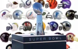 A Lombardi Trophy with all 32 NFL team's helmets behind it