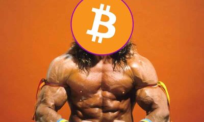 An intense muscular man flexing with a Bitcoin logo over his face