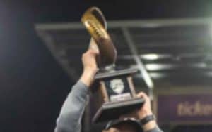 hoisting a championship trophy after a bowl game win