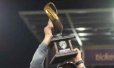 hoisting a championship trophy after a bowl game win