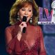 Reba McEntire singing in front of a Super Bowl 58 logo
