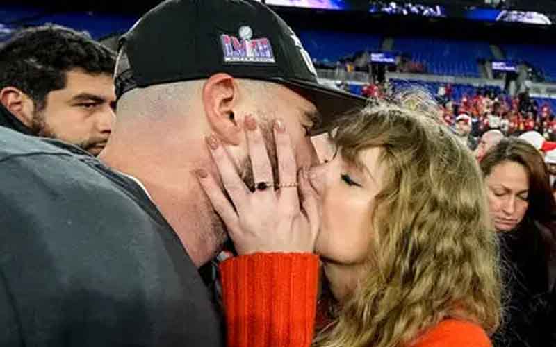 Taylor Swift and Travis Kelce kissing after the 2023-24 AFC Championship Game