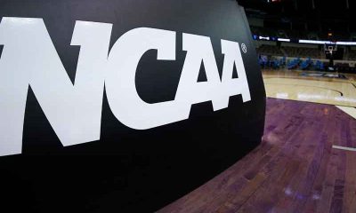 an NCAA logo on a pad at the bottom of a basketball hoop